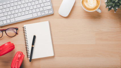 Office desk worklace with keyboard, mouse, noebook, eyeglass, pen, headphone and cup of coffee, Top view flat lay with copy space.
