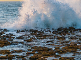 Sunrise and clouds over the ocean and rock platform