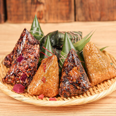 zongzi, rice dumplings,Made with glutinous rice and meat or egg yolk, wrapped in zong leaves