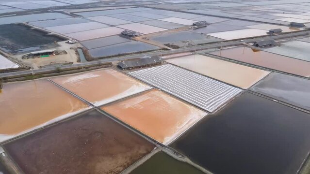 Aerial View Sea Salt Farms in Thailand. Dolly Shot.