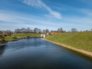 Fototapeta na wymiar Kastelet, pentagonal start fort in Copenhagen with restored moat, ramparts, ravelin, bridge over the moat