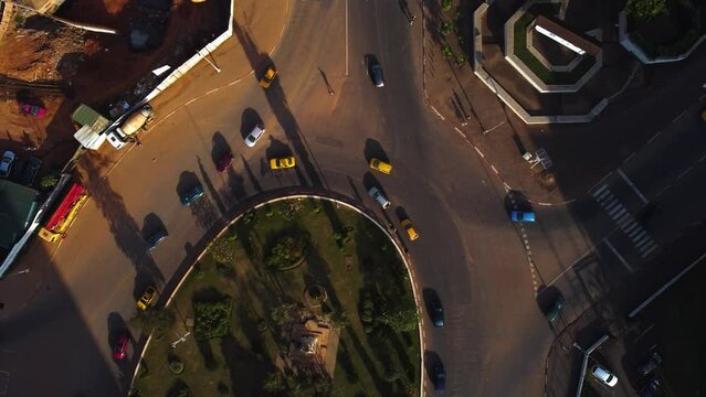 Aerial view above traffic, revealing the downtown of Yaounde, Cameroon - tilt, drone shot