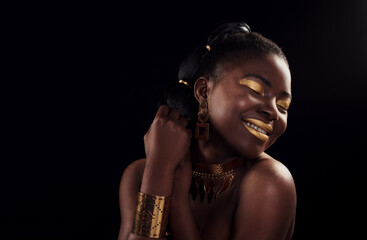 Beauty, gold and black woman in studio for makeup, art and elegance against a black background. Rich, creative and African female model pose with jewelry for wealth, royal and luxury queen aesthetic