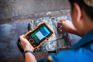 UT, Ultrasonic testing to detect imperfection or defect in welding of steel structure outside. NDT...