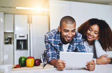 Couple, tablet and cooking with recipe in kitchen at home for food blog, internet website and online connection. Happy man, woman and digital technology for reading healthy vegan meal instructions