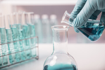 chemist,scientist hand pick up and dropping chemical liquid into test tube, science research and development concept