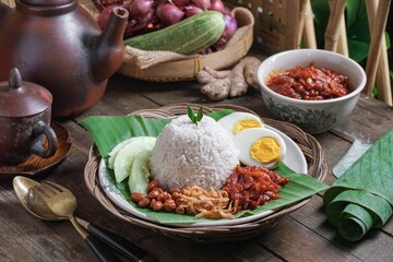 Asian cuisine Nasi Lemak is a rice dish infused with coconut milk. Served with sambal sauce, fried...