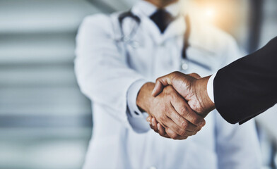Closeup, doctor and man with handshake, consultation and partnership for healthcare development,...
