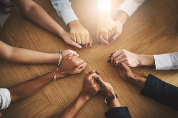 Support, diversity and people holding hands by a table at a group counseling or therapy session. Gratitude, trust and friends in a circle for praying together for religion, community and connection. - obrazy, fototapety, plakaty
