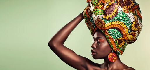 Makeup, fashion and black woman in head wrap in studio for culture, glow and cosmetics on green...