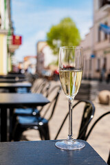 sparkling wine in flute glasses on outdoor cafe or bistro terrace