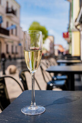 sparkling wine in flute glasses on outdoor cafe or bistro terrace