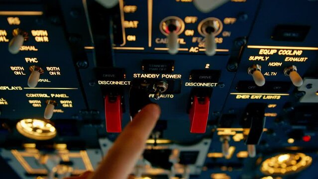 Airplane cabin The pilot checks the plane's electronics by pressing the buttons Preparing the passenger liner for takeoff