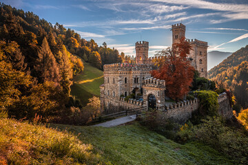 Latzfons, Italy - Beautiful autumn scenery at Gernstein Castle (Castello di Gernstein, Schloss Gernstein) at sunrise in South Tyrol with blue sky and golden foliage