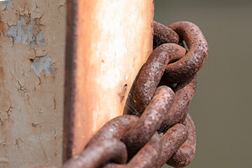 Rusted metal chain and fence post