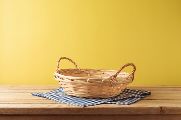 Brazilian Festa Junina summer harvest festival concept. Empty basket with tablecloth on wooden...