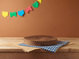 Brazilian Festa Junina summer harvest festival concept. Empty wooden podium with tablecloth on...