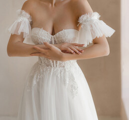 Trendy classic wedding dress with cleavage and wide short sleeves decorated with floral lace. Bride...