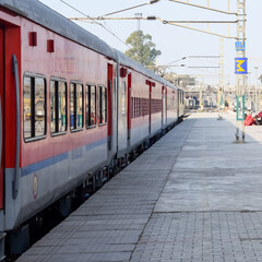 Obraz premium Indian railway train at Amritsar railway station platform during morning time, Colourful train at Amritsar, Punjab railway station