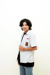 Indonesian male high school students wearing gray and white uniforms. Isolated on a Blue background.