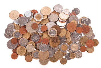 assorted coins from different countries close up isolated on white background