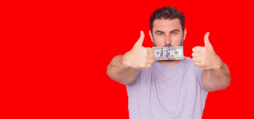 Business man hold money on red banner. Rich man in suit with money dollar bills. Successful businessman with dollar banknotes. Rich millionaire in t-shirt holding money on red studio.