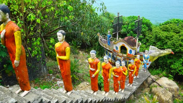 Statues of monks in orange clothes coming from the ship