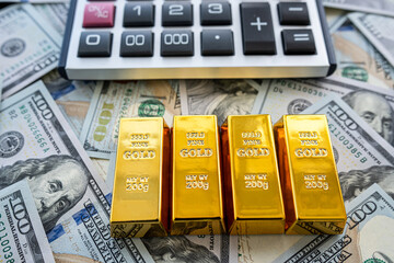 Gold bullion over 100 us dollar money, investment and wealth concept