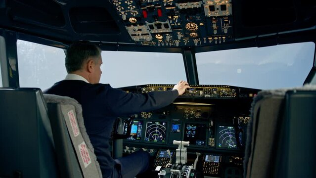Commercial aircraft pilot adjusts aircraft flight parameters during high altitude flight View from inside the cabin