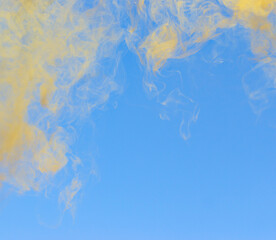 Fototapeta na wymiar yellow smoke on blue background