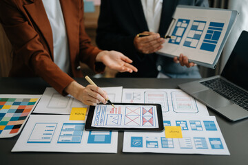  UX developer and ui designer brainstorming about mobile app interface wireframe design with...