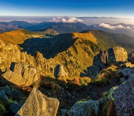 Mountainous landscape with hills and valleys at a sunny day in autumn season. Dumbier, the highest peak of the Low Tatras National Park in background, Slovakia, Europe