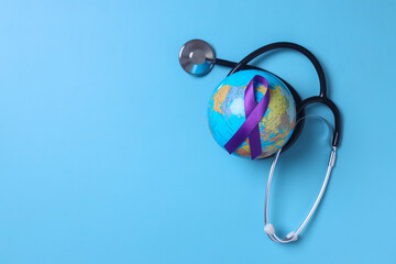 Stethoscope wrapped around globe with purple ribbon awareness on pastel blue background. World epilepsy day.