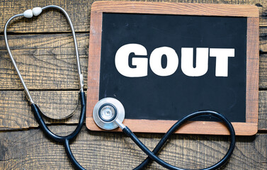 The word Gout on a chalkboard next to a stethoscope.
