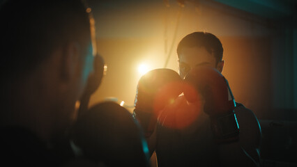 boxers fight in the ring at night