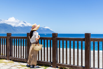 Tourist woman look at sea beach