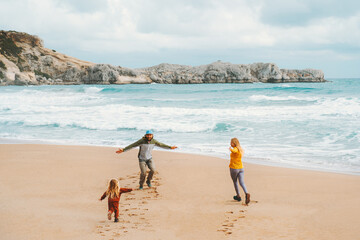 Family mother and father playing with child on the beach outdoor travel lifestyle vacations parents with kid walking together happy people sea landscape