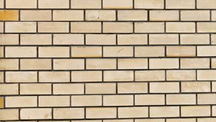 Texture, background and frame made of abstract beige brick. Brickwork wall