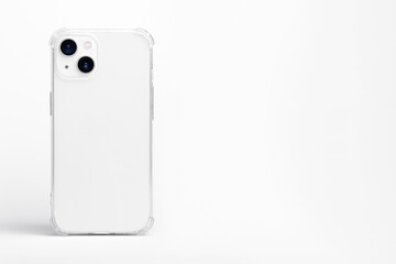 white iPhone 14 Plus and 13 mini in clear transparent soft silicone case back view. Phone case mockup isolated on grey background. Banner with place for text on the right