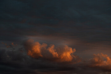 Fototapeta na wymiar Orange and red cloudy sky at dusk in spring.