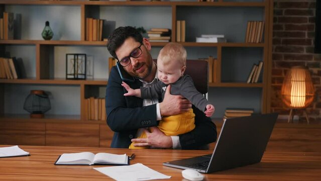 Businessman in formal clothes is working indoors. With toddler that is crying.