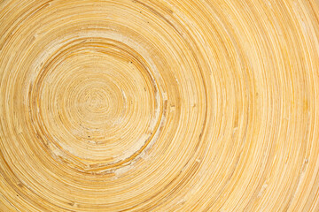 Fototapeta na wymiar Top view of empty wooden bamboo plate closeup texture of circular pattern with copy space in horizontal format.