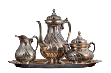 Tea pot, sugar bowl and milk container standing on a tray, a set of dishes. Metal, decorative, antique objects. On a transparent background.