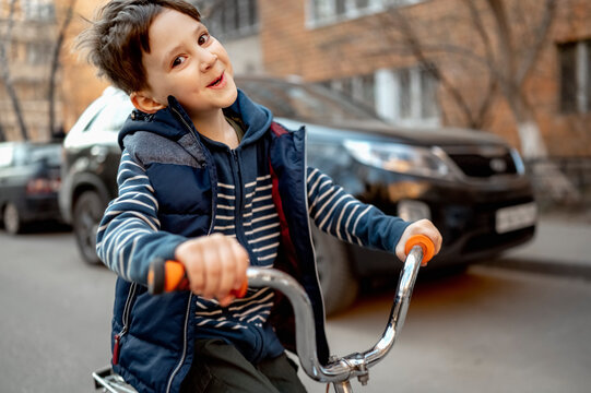 Smiling boy riding bicycle on road