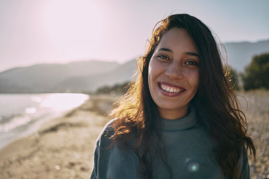 Happy woman with long hair at beach