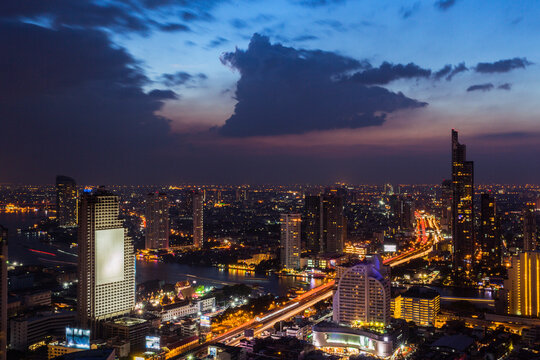Thailand, Bangkok, Clouds over city downtown at dusk