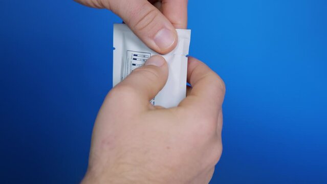 Tear plastic protective wrapping with self-testing immunological rapid test device