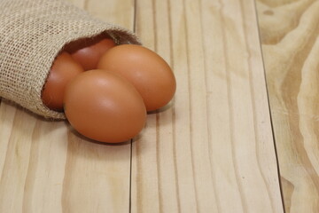 raw eggs on wooden background