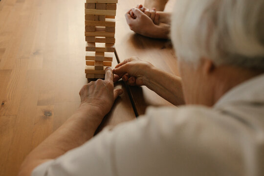Elderly woman playing game on table at home