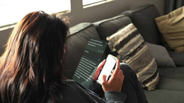 Woman on couch looking at smart phone, VFX animation motion graphics overlay of text message